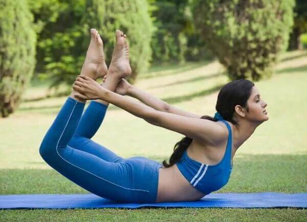 Athletic Woman Doing A Headstand With Bow And Arrow Legs As She Works Out  On A Yoga Mat In A Side View Over Black With Copy Space Stock Photo,  Picture and Royalty